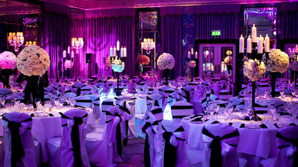 Premium corporate event setup with stage, audience and networking